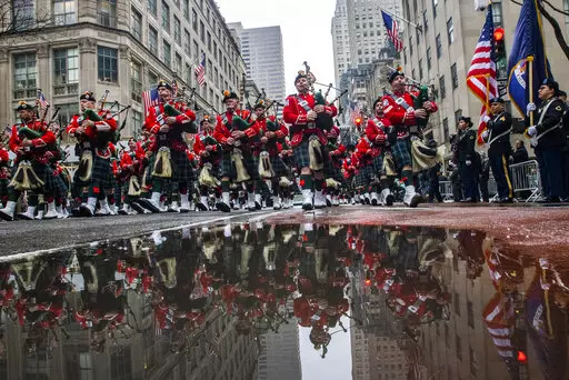 Bagpipers march up Fifth Avenue while they pass in front of St. Patrick Cathedral during the St. Patrick's Day Parade, Thursday, March 17, 2022, in New York.  St. Patrick’s Day celebrations across the country are back after a two-year hiatus. That includes New York City's parade, the nation's largest and oldest. It's a sign of growing hope that the worst of the coronavirus pandemic may be over. (AP Photo/Eduardo Munoz Alvarez)