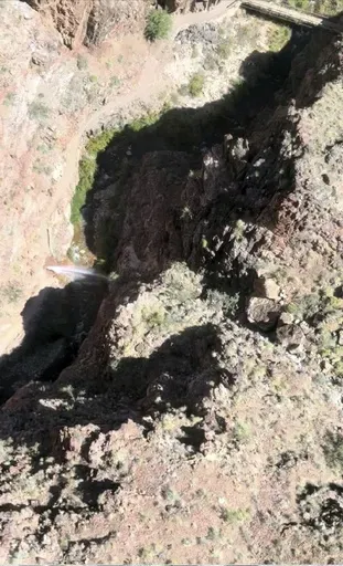 In this photo provided by the National Park Service, water shoots out of a pipeline that broke along the North Kaibab Trail on Aug. 20, 2024 at Grand Canyon National Park, Ariz. (National Park Service via AP)