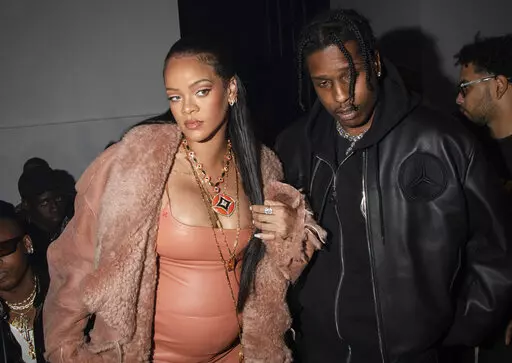 Rihanna, left, and ASAP Rocky appear at the Off-White Ready To Wear Fall/Winter 2022-2023 fashion collection, in Paris on Feb. 28, 2022. Now in her third trimester, the music star, and fashion and beauty mogul hasn't exactly been hiding under a maternity tent since she and boyfriend A$AP Rocky announced they were expecting. She's made the fashion week rounds in Milan and Paris wearing a range of couture that shows off her belly. (Photo by Vianney Le Caer/Invision/AP, File)
