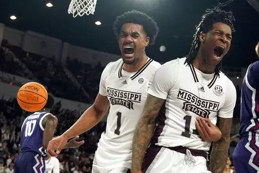 Mississippi State forward Tyler Stevenson, right, and forward Tolu Smith (1) celebrate after scoring and drawing a foul from a TCU player during the second half of an NCAA college basketball game in Starkville, Miss., Saturday, Jan. 28, 2023. (AP Photo/Rogelio V. Solis)