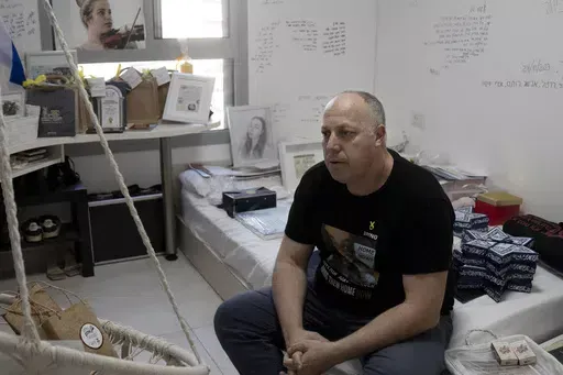 Shlomi Berger sits in his daughter's bedroom in Holon, Israel, Wednesday, April 17, 2024. Agam, 19, was abducted two days after the start of her army service along the border with Gaza during a cross-border attack by Hamas on Oct. 7, 2023. "The Passover story says we come from slaves to free people, so this is a parallel story," Berger said. "This is the only thing I believe that will happen. That Agam will get out from darkness to light. She and all of the other hostages." (AP Photo/Maya Alleru