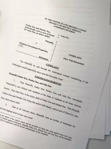 A lawsuit is seen on Thursday, July 27, 2023, in Atlanta. The parents of a teenager with special needs say he was repeatedly sexually assaulted and raped by an employee at the small private boarding school in South Carolina. They have sued the school's parent company, which has denied the allegations. (AP Photo/Brynn Anderson)