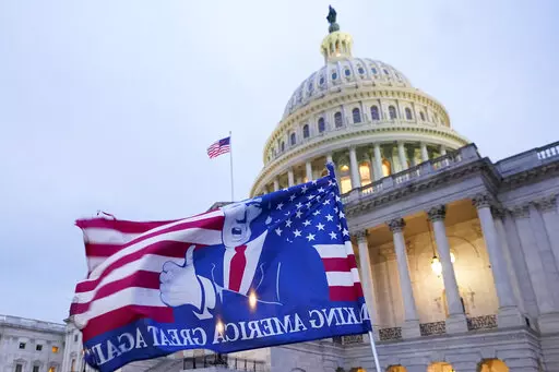 A flag depicting President Donald Trump flies on the East Front of the U.S. Capitol on Jan. 6, 2021, in Washington. (AP Photo/Manuel Balce Ceneta)