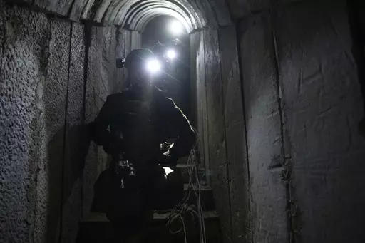 Israeli soldiers show journalists an underground tunnel where the Israeli military said it had found evidence hostages were held by militants in Khan Younis, Gaza Strip, on Wednesday, Jan. 10. 2024. The tunnel was located near destroyed homes and streets in a city that's become the focus of Israel's ground offensive. (AP Photo/Ohad Zwigenberg)