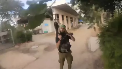This image made from undated bodycam video footage taken by a downed Hamas militant and released by Israel Defense Forces shows a Hamas militant walking around a residential neighborhood at an undisclosed location in southern Israel. Israel's military brought together a group of foreign correspondents Monday, Oct. 16, 2023, to screen a 40-minute reel of gruesome footage compiled from the Hamas attack last week. The screening came as Israel's military faces increasing pressure to back up their cl