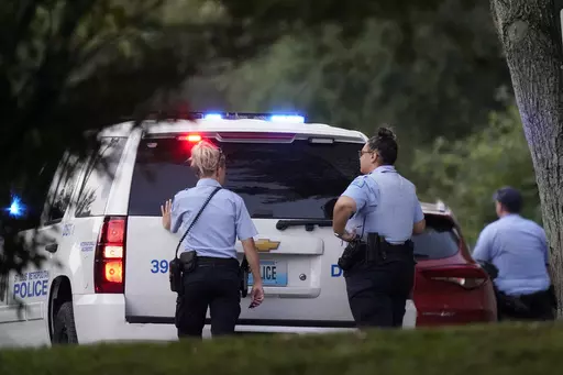 Police take up positions near the scene of a shooting Saturday, Aug. 29, 2020, in St. Louis. Ten years after gaining local control of its police for the first time since the Civil War, the city of St. Louis has even more murders than before — and Missouri lawmakers are again considering a state takeover of the police force. (AP Photo/Jeff Roberson, File)