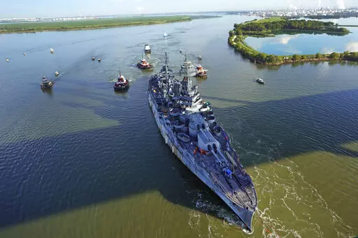 The USS Texas is towed down the Houston Ship Channel Wednesday, Aug. 31, 2022, in Baytown, Texas. The vessel, which was commissioned in 1914 and served in both World War I and World War II, is being towed to a dry dock in Galveston where it will undergo an extensive $35 million repair. (AP Photo/David J. Phillip)