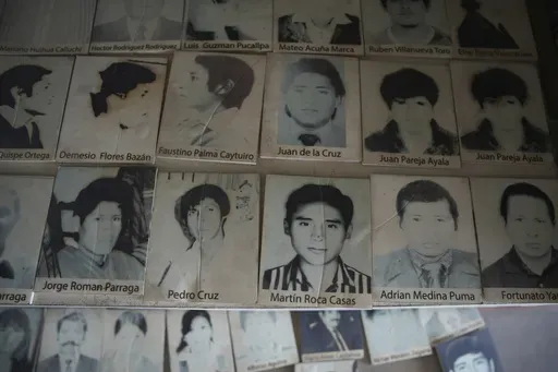 Photos of people who disappeared during Peru's internal armed conflict (1980-2000) lie on display at the House of Memory museum in Lima, Peru, Sunday, Oct. 20, 2024. (AP Photo/Guadalupe Pardo)