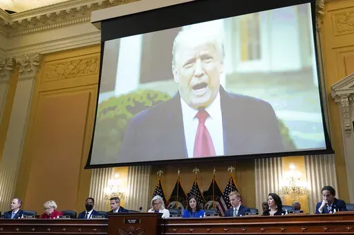 A video of President Donald Trump is shown on a screen, as the House select committee investigating the Jan. 6 attack on the U.S. Capitol holds a hearing at the Capitol in Washington, July 21, 2022. On Monday, Dec. 19, the House committee will make its final case to the American people about the unprecedented effort by former President Donald Trump to overturn the 2020 election and why the Justice Department should pursue criminal charges in connection to it. (AP Photo/J. Scott Applewhite, File)