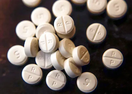 This June 17, 2019, file photo shows 5-mg pills of Oxycodone. The nation's top public health agency on Thursday proposed changing — and in some instances, dulling — guidelines for U.S. doctors prescribing oxycodone and other opioid painkillers.(AP Photo/Keith Srakocic, File)