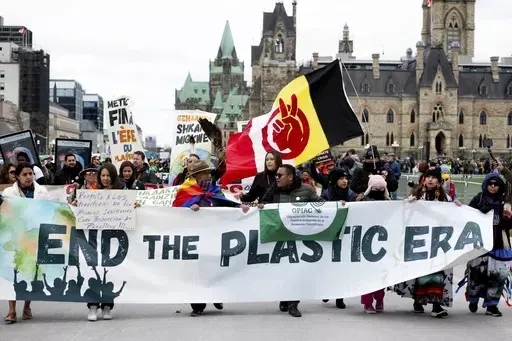 People participate in a March to End the Plastic Era on Parliament Hill in Ottawa, Ontario, on April 21, 2024. (Spencer Colby/The Canadian Press via AP, File)