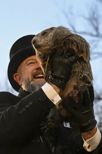 Groundhog Club handler A.J. Dereume holds Punxsutawney Phil, the weather prognosticating groundhog, during the 139th celebration of Groundhog Day on Gobbler's Knob in Punxsutawney, Pa., Sunday, Feb. 2, 2025. (AP Photo/Barry Reeger)