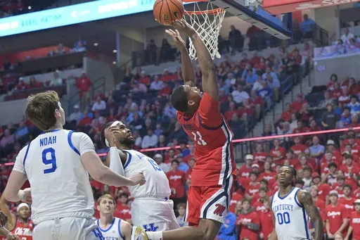 Mississippi guard Matthew Murrell (11) scores past Kentucky forward Ansley Almonor (15) during the first half of an NCAA college basketball game in Oxford, Miss., Tuesday, Feb. 4, 2025. (AP Photo/Bruce Newman)