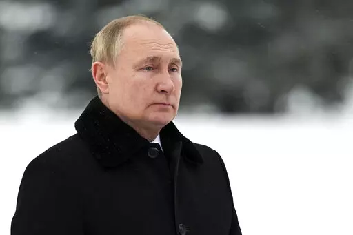In this Jan. 27, 2022, photo, Russian President Vladimir Putin attends a wreath laying commemoration ceremony at the Piskaryovskoye Cemetery where most of the Leningrad Siege victims were buried during World War II, in St. Petersburg, Russia. The White House and U.S officials have threatened Russia with financial sanctions carrying “severe consequences” if Moscow invades Ukraine, but so far plenty of individuals have been prime targets for Western pain. Experts say it’s unlikely the U.S. a