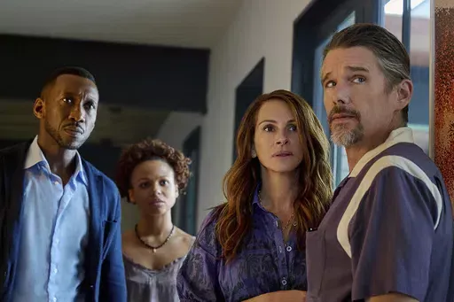 This image released by Netflix shows Mahershela Ali from left, Myha'la Herrold, Julia Roberts and Ethan Hawke in a scene from "Leave the World Behind." (JoJo Whilden/Netflix via AP)
