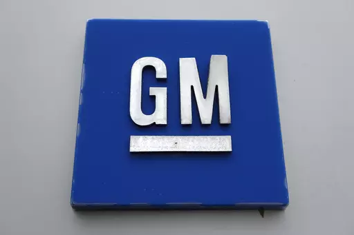 The General Motors logo is displayed outside the General Motors Detroit-Hamtramck Assembly plant, Jan. 27, 2020, in Hamtramck, Mich. General Motors is offering buyouts to most of its U.S. salaried workforce and some global executives in an effort to trim costs as it makes the transition to electric vehicles. (AP Photo/Paul Sancya, File)