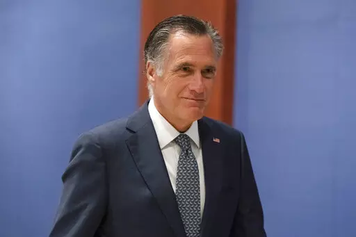 Sen. Mitt Romney, R-Utah, arrives to watch a speech by Ukrainian President Volodymyr Zelenskyy live-streamed into the U.S. Capitol, in Washington, March 16, 2022. Lawmakers seemed on the brink of clinching a bipartisan compromise Thursday, March 31, to provide a fresh $10 billion to combat COVID-19. Romney said bargainers had reach an agreement in principle on a package but said it was still being drafted. Other senators were less definitive but none contested that a deal was near. (AP Photo/Ale