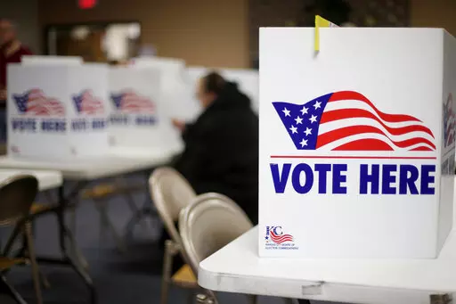 A woman votes in the presidential primary election at the the Summit View Church of the Nazarene in Kansas City, Mo., on March 10, 2020. Newspaper endorsements for candidates are fading away, a victim of both the news industry's troubles and the era's bitter politics. Earlier this month, newspapers controlled by hedge fund Alden Global Capital said they would no longer endorse candidates for president, governor and U.S. Senate. They include dozens of dailies like the Chicago Tribune, New York Da