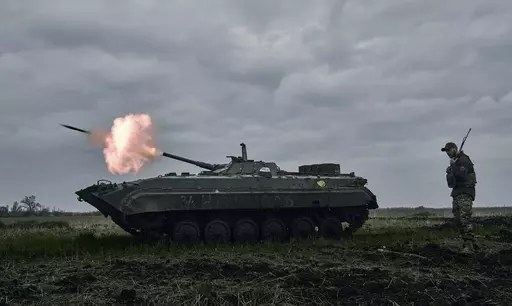 A Ukrainian APC fires towards Russian positions near Avdiivka, in the Donetsk region, Ukraine, Friday, April 28, 2023. A dayslong attempt by Russian forces to storm a strategically important city in eastern Ukraine appears to be running out of steam, Kyiv officials claimed Monday, Oct. 16, 2023 as the Kremlin’s war entered its 600th day. (AP Photo/Libkos, File)