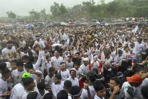 Hundreds of Rohingyas gather in the rain to demand safe return to Myanmar's Rakhine state as they mark the seventh anniversary of their mass exodus from Myanmar at their refugee camp at Kutupalong in Cox's Bazar district, Bangladesh, Sunday, Aug. 25, 2024. (AP Photo/ Shafiqur Rahman)