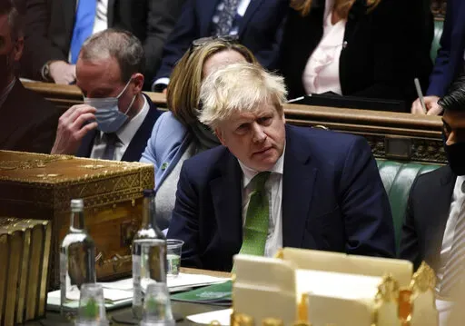 In this photo provided by UK Parliament, Britain's Prime Minister Boris Johnson attends Prime Minister's Questions in the House of Commons, in London, Jan. 19, 2022. Some Conservative lawmakers in Britain are talking about ousting Johnson, who has been tarnished by allegations that he and his staff held lockdown-breaching parties during the coronavirus pandemic. The party has a complex process for changing leaders that starts by lawmakers writing letters to demand a no-confidence vote. (Jessica 