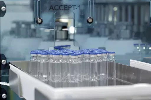 In this image provided by the Serum Institute of India, vials of freshly manufactured Novavax COVID-19 vaccines wait to be labeled in 2022, in Pune, India. The U.S. is getting another COVID-19 vaccine choice as the Food and Drug Administration on Wednesday, July 13, 2022, cleared Novavax shots for adults. (Serum Institute of India for Novavax via AP)