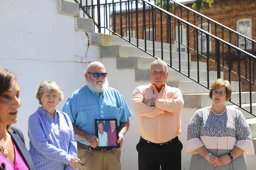 The families of two sisters killed in 2010 in Kingstree, S.C., stand by attorney Lori Murray, far left, who asks prosecutors to release information about why the man charged in the killings has been set free after being found incompetent to stand trial, at a news conference, Monday, May, 9, 2022, in Kingstree. (AP Photo/Jeffrey Collins)