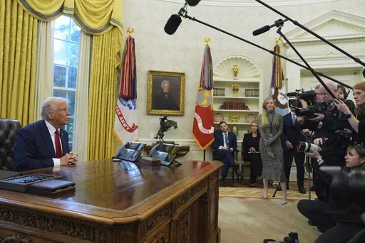 President Donald Trump talks with reporters as he signs executive orders in the Oval Office at the White House, Thursday, Jan. 30, 2025, in Washington. (AP Photo/Evan Vucci)