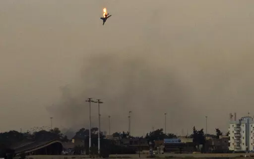 A war plane is shot down over the outskirts of Benghazi, eastern Libya, Saturday, March 19, 2011. On Friday, Feb. 25, 2022, The Associated Press reported that footage of the plane crashing in Libya in 2011 circulated online with false claims that it was captured during Russia's 2022 invasion of Ukraine. (AP Photo/Anja Niedringhaus)