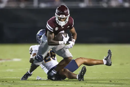 Mississippi State wide receiver Kevin Coleman Jr. (3) tries to gain yards after a catch against Toledo safety Braden Awls (26) during the first half of an NCAA college football game in Starkville, Miss., Saturday, Sept. 14, 2024. (AP Photo/James Pugh)
