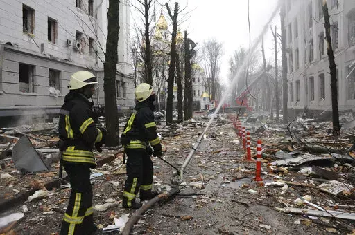 Firefighters extinguish a building of Ukrainian Security Service (SBU) after a rocket attack in Kharkiv, Ukraine's second-largest city, Ukraine, March 2, 2022.  President Joe Biden has called Russia’s war on Ukraine a genocide and accused Vladimir Putin of committing war crimes. But his administration has for weeks grappled with how much intelligence it's willing to give Ukrainian forces trying to stop Putin. (AP Photo/Andrew Marienko, File)