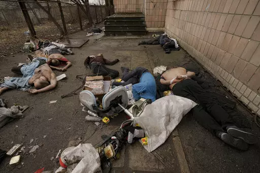 EDS NOTE: GRAPHIC CONTENT - FILE - Lifeless bodies of men, some with their hands tied behind their backs, lie on the ground in Bucha, Ukraine, Sunday, April 3, 2022. Russian soldiers picked up these men on March 4, 2022, as they swept the streets of Bucha to identify and neutralize potential threats. Ukrainian prosecutors now say they know who was responsible for the violence that day: Soldiers from the 76th Guards Airborne Assault Division, who ultimately reported up to Col. Gen. Alexander Chai
