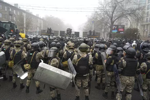 Riot police block a street to prevent demonstrators during a protest in Almaty, Kazakhstan, Wednesday, Jan. 5, 2022. Demonstrators denouncing the doubling of prices for liquefied gas have clashed with police in Kazakhstan's largest city and held protests in about a dozen other cities in the country. (AP Photo/Vladimir Tretyakov)