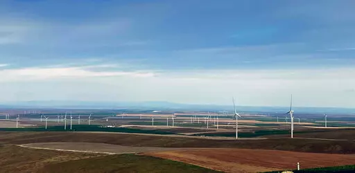 In this photo provided by Portland General Electric, windmills are seen at a renewable energy facility in Lexington, Ore., May 24, 2022, that combines solar power, wind power and massive batteries to store the energy generated there. The Wheatridge Renewable Energy Facilities was commissioned Wednesday, Sept. 28, 2022, and is the first utility-scale plant of its kind in North America. Clean energy experts say the project, which can power 100,000 homes, addresses some key challenges facing the in