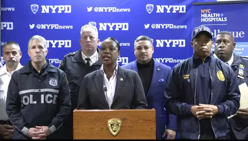 This photo provided by NYPD, New York City Police Commissioner Keechant Sewell address the media during a news conference on Saturday, Dec. 31, 2022. A man wielding a machete attacked three police officers at the New Year’s Eve celebration in New York City, authorities said, striking two of them in the head before an officer shot the man in the shoulder. The two officers were hospitalized, one with a fractured skull and the other with a bad cut, but expected to recover. (NYPD via AP)