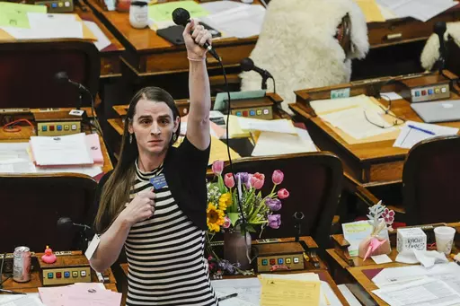 Montana state Rep. Zooey Zephyr, D-Missoula, alone on the House floor stands in protest as demonstrators are arrested in the House gallery, Monday, April 24, 2023, at the state Capitol in Helena, Mont. Montana's Republican Gov. Greg Gianforte signed a bill Friday, April 28, to ban gender-affirming medical care for young transgender people — the battle over which ended with the removal of a transgender lawmaker from the House floor. (Thom Bridge/Independent Record via AP, File)