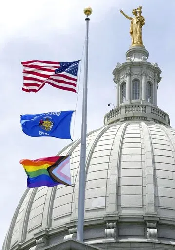 In this Wednesday, June 1, 2022, photo, a Rainbow Pride flag is raised at the Capitol in Madison, Wis. A Wisconsin school board has voted in favor of a policy that prohibits teachers and staff from displaying gay pride flags and other items that district officials consider political in nature. (Mark Hoffman/Milwaukee Journal-Sentinel via AP, File)