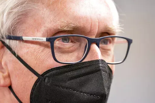Wisconsin Gov. Tony Evers listens during a gathering of about 50 Democrats at a party headquarters Saturday, Jan. 8, 2022, in Janesville, Wis. The 70-year-old grandfather and former teacher is trying to convince voters that he's also a valiant defender of democracy and the lone figure ensuring their votes will still matter in 2024 and beyond. (AP Photo/Andy Manis)
