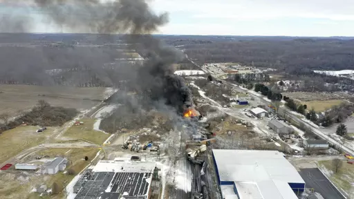 This photo taken with a drone shows portions of a Norfolk and Southern freight train that derailed Friday night in East Palestine, Ohio are still on fire at mid-day Saturday, Feb. 4, 2023. The federal government filed a lawsuit Thursday, March 30, against railroad Norfolk Southern over environmental damage caused by a February derailment on the Ohio-Pennsylvania border that spilled hazardous chemicals into nearby creeks and rivers. (AP Photo/Gene J. Puskar, File)