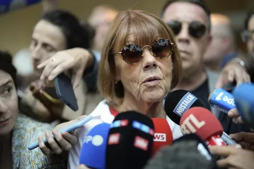 Gisele Pelicot speaks to media as she leaves the Avignon court house, southern France, Thursday, Sept. 5, 2024. (AP Photo/Lewis Joly, File)