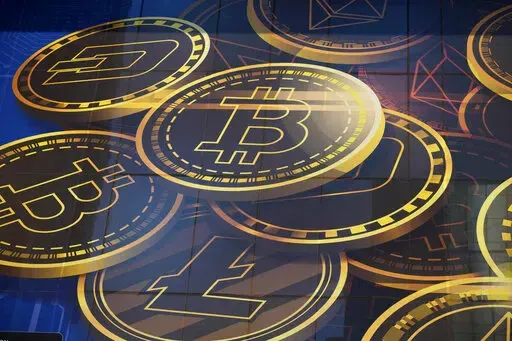 An advertisement of Bitcoin, one of the cryptocurrencies, is displayed on a building in Hong Kong, on Nov. 18, 2021.  Originally a misspelling in an online forum, the term “HODL” has become gospel among some owners of bitcoin and other cryptocurrencies.  (AP Photo/Kin Cheung, File)