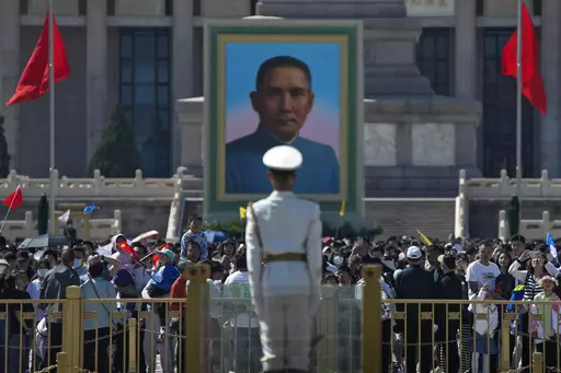 Visitors gather near a portrait of Sun Yat-sen, who is widely regarded as the founding father of modern China, at Tiananmen Square during the May Day holiday period in Beijing, Sunday, April 30, 2023. (AP Photo/Andy Wong)