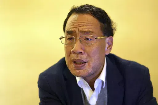 Virologist Zhang Yongzhen speaks at a coffeeshop in Shanghai, China on Dec. 13, 2020. Zhang, the first scientist to publish a sequence of the COVID-19 virus in China was staging a sit-in protest after authorities locked him out of his lab. Zhang wrote in an online post on Monday, April 29, 2024, that he and his team were suddenly notified they were being evicted from their lab, the latest in a series of setbacks, demotions and ousters since he first published the sequence in early January 2020. 