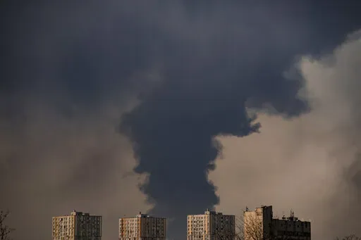 Heavy smoke billows after a Russian bombardment on the outskirts of Kyiv, Ukraine, Friday, March 25, 2022. With stunning speed, Russia's war in Ukraine is driving Western Europe into the outstretched arms of the United States again, and the embrace was especially apparent when President Joe Biden offered a major expansion of natural gas shipments to his European Union counterpart Friday. (AP Photo/Vadim Ghirda)