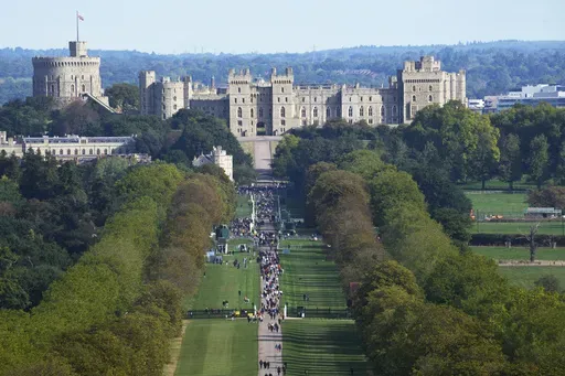 People make their way along the Long Walk towards Windsor Castle in Windsor, England, Sept. 18, 2022. (AP Photo/Gregorio Borgia, File)