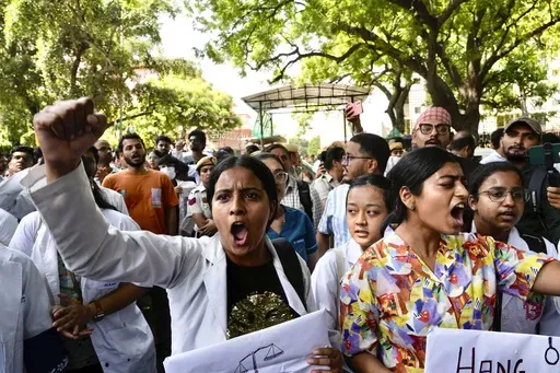 Doctors and paramedics protest against the rape and killing of a trainee doctor in Kolkata at a government hospital last week, as they gather in front of the Indian health minister's office, in New Delhi, India, Friday, Aug. 16, 2024. (AP Photo/Manish Swarup)