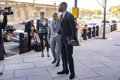 Prakazrel "Pras" Michel, a member of the 1990s hip-hop group the Fugees, accompanied by defense lawyer David Kenner, center left, arrives at federal court for his trial in an alleged campaign finance conspiracy, Monday, April 3, 2023, in Washington. (AP Photo/Andrew Harnik)