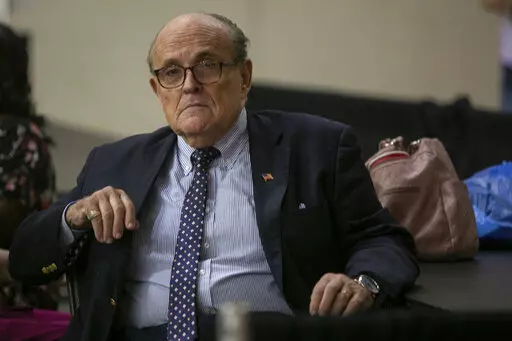 Former New York City Mayor Rudy Giuliani sits where delegate votes will be counted as nominee for statewide positions are introduced during the Michigan Republican convention at Devos Place in Grand Rapids, Mich., on Saturday, April 23, 2022. (Daniel Shular/The Grand Rapids Press via AP)