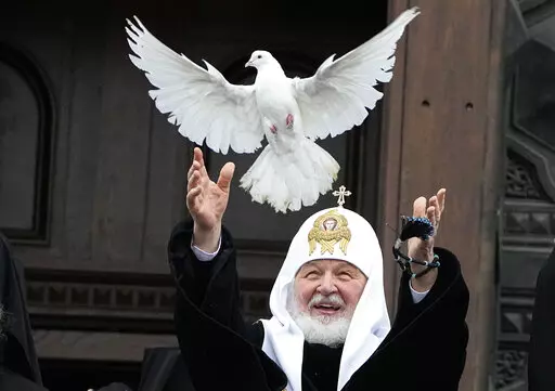 Russian Orthodox Church Patriarch Kirill releases a bird celebrating the Annunciation preceding the celebration of Orthodox Easter in front of the Christ the Savior Cathedral in Moscow, Russia, Thursday, April 7, 2022. (AP Photo/Alexander Zemlianichenko)