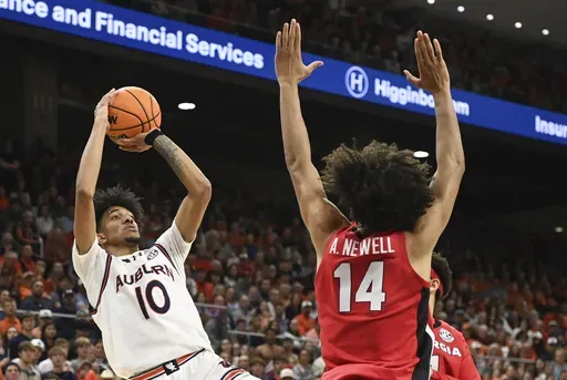 Auburn forward/guard Chad Baker-Mazara (10) shoots over Georgia forward Asa Newell (14) during the second half an NCAA college basketball game Saturday, Feb. 22, 2025, in Auburn, Ala. (AP Photo/Julie Bennett)